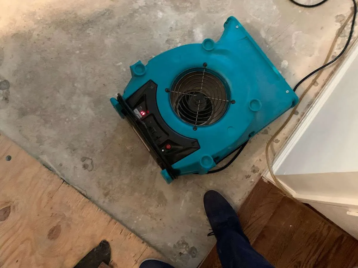 Air mover drying subfloor during Commercial Water Damage Restoration in High Point